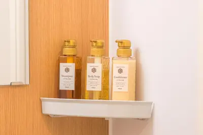 three bottles of essential oils on a shelf at \u548c\u306e\u5bbf\u30db\u30c6\u30ebYamatoinn Akihabara#101 in Tokyo