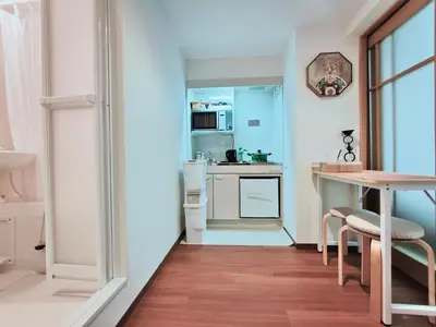 a small kitchen with a table and a counter top at Moon Hotel in Tokyo