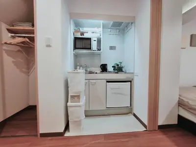 a small kitchen with a sink and a microwave at Moon Hotel in Tokyo