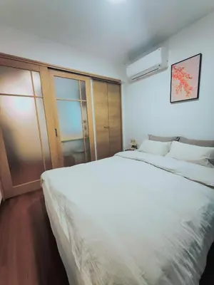 a bedroom with two white beds and a window at Moon Hotel in Tokyo