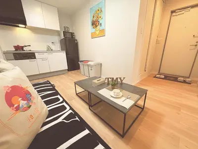 a living room with a table and a kitchen at \u548c\u306e\u5bbf\u30db\u30c6\u30ebYamatoinn Akihabara#201 in Tokyo