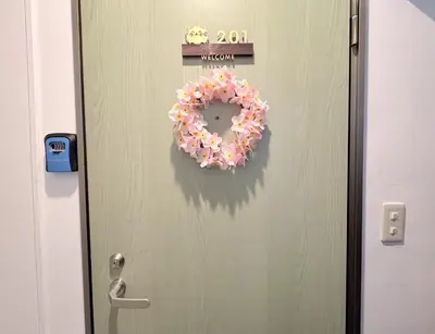a door with a wreath on it with a sign on it at \u548c\u306e\u5bbf\u30db\u30c6\u30ebYamatoinn Akihabara#201 in Tokyo
