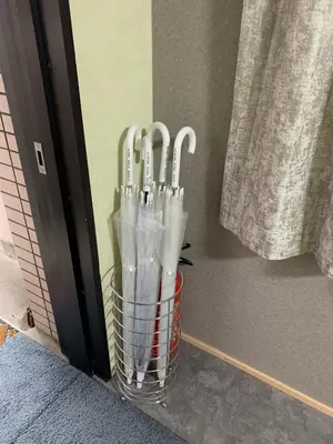 a basket full of umbrellas sitting next to a door at HOTEL PRELE Shinkan \u30db\u30c6\u30eb\u30d7\u30ec\u30fc\u30eb\u65b0\u9928 in Tokyo