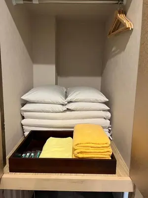 two stacks of towels on a shelf in a closet at HOTEL PRELE Shinkan \u30db\u30c6\u30eb\u30d7\u30ec\u30fc\u30eb\u65b0\u9928 in Tokyo