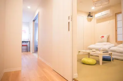 a hallway with a room with a couch and a table at \u548c\u306e\u5bbf\u30db\u30c6\u30ebYamatoinn Akihabara#301 in Tokyo