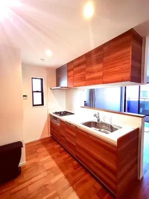 a kitchen with wooden cabinets and a sink at Ueno new villa in Tokyo