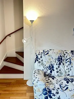 a living room with a couch and a lamp at Ueno new villa in Tokyo