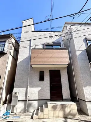 a white brick building with a door and stairs at Ueno new villa in Tokyo