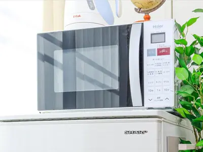 a microwave sitting on top of a refrigerator at Skytree 13 minute drive Exclusive whole home stay in Tokyo