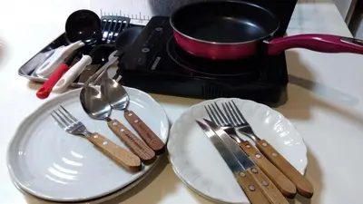 two white plates with utensils on a table at Sun and Moon\u30db\u30c6\u30eb302 in Tokyo