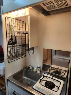 a kitchen with a sink and a stove at \u5409\u5c4b-\u65b0\u5bbf in Tokyo