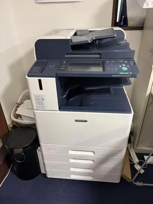 a printer is sitting on top of a desk at \u5409\u5c4b-\u65b0\u5bbf in Tokyo
