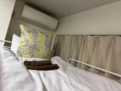 a hospital bed with a pillow and a blanket at \u5409\u5c4b-\u65b0\u5bbf in Tokyo