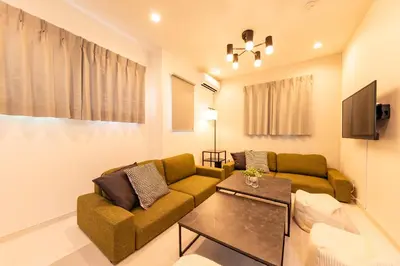 a living room with a couch and a table at Enjoy Tokyo Hotel in Tokyo