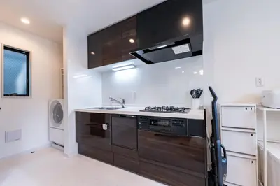 a kitchen with a stove and a refrigerator at Enjoy Tokyo Hotel in Tokyo