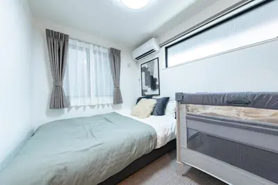 a bedroom with two beds and a window at Enjoy Tokyo Hotel in Tokyo