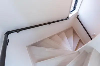 a stairwell in a house with a window at Enjoy Tokyo Hotel in Tokyo