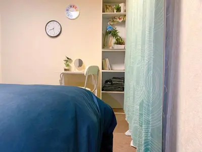 a bedroom with a bed and a desk and a clock at Toyo Shinagawa in Tokyo