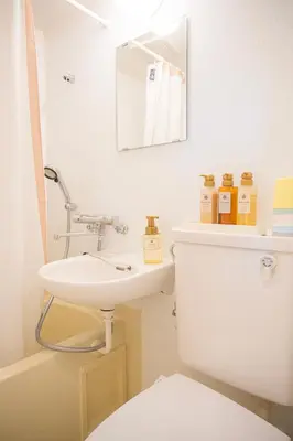 a bathroom with a sink and a toilet and a mirror at \u548c\u306e\u5bbf\u30db\u30c6\u30ebYamatoinn Akihabara#401 in Tokyo