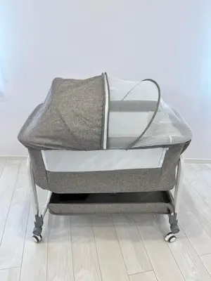 an empty baby crib on a metal cart at MY House YANESEN Tokyo2 in Tokyo