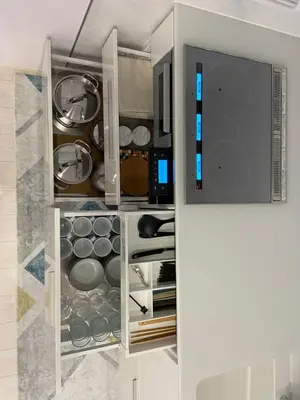 a kitchen with a cupboard filled with pots and pans at MY House YANESEN Tokyo2 in Tokyo