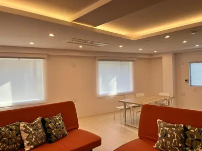 a living room with a table and a couch at MY House YANESEN Tokyo2 in Tokyo