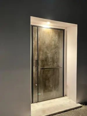 a metal door in a wall with a light on it at MY House YANESEN Tokyo2 in Tokyo