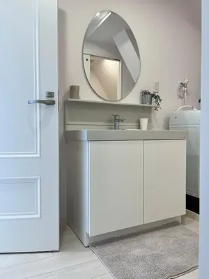 a bathroom with a white sink and a mirror at MY House YANESEN Tokyo in Tokyo