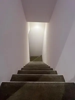 a staircase in a white room with a light at the top at MY House YANESEN Tokyo in Tokyo
