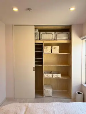 a walk in closet with wooden shelves at MY House YANESEN Tokyo in Tokyo