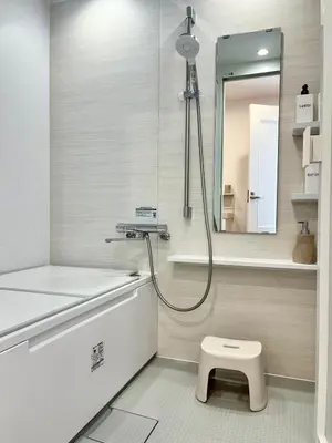 a bathroom with a shower and a toilet and a mirror at MY House YANESEN Tokyo in Tokyo