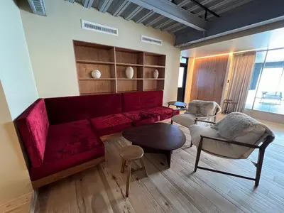 a living room with a red couch and chairs at \u30a2\u30f3\u30c9\u30b9\u30c6\u30a4\u6771\u5411\u5cf66\u4e01\u76ee2f in Tokyo