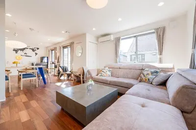 a living room with a couch and a table at FRt\u5e73\u4e95\u6238\u5efa\u3066 in Tokyo
