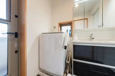 a bathroom with a sink and a refrigerator at FRt\u5e73\u4e95\u6238\u5efa\u3066 in Tokyo