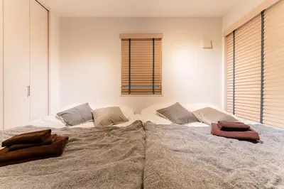 a bedroom with a large bed with two pillows on it at STs\u7b39\u585a2\u4e01\u76ee in Tokyo
