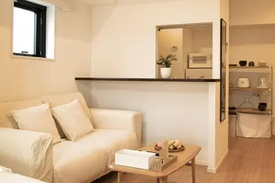 a living room with a white couch and a table at 1001 Deluxe Double Room in Tokyo