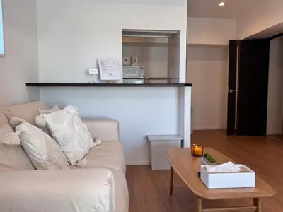 a living room with a couch and a table at 1001 Deluxe Double Room in Tokyo