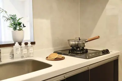 a kitchen with a sink and a pot on a stove at 1001 Deluxe Double Room in Tokyo