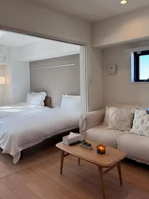 a bedroom with a bed and a couch and a table at 1001 Deluxe Double Room in Tokyo