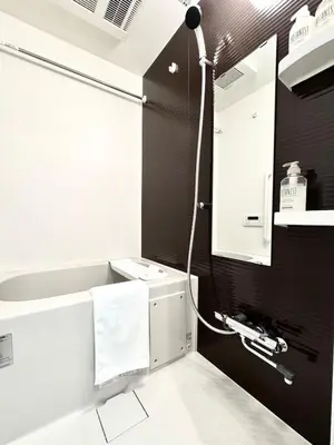 a bathroom with a white sink and a shower at 1001 Deluxe Double Room in Tokyo