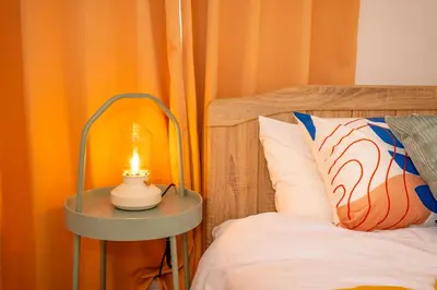 a lamp sitting on a table next to a bed at HOTEL Flag Tokyo in Tokyo