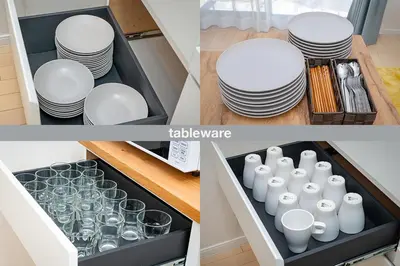 a drawer full of plates and glasses in a kitchen at HOTEL Flag Tokyo in Tokyo