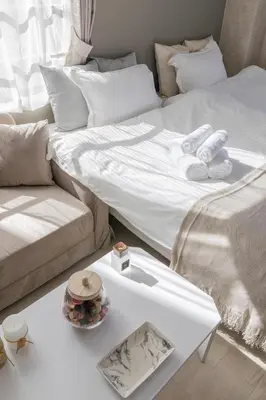 a white bed and a couch and a table at FRt\u6075\u6bd4\u5bff2\u4e01\u76ee303 in Tokyo