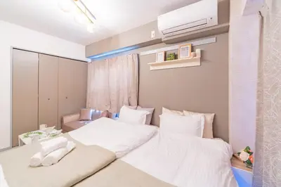 a bedroom with two beds with white sheets at FRt\u6075\u6bd4\u5bff2\u4e01\u76ee303 in Tokyo