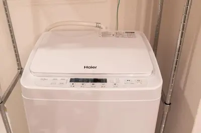 a white washing machine sitting in a room at FRt\u6075\u6bd4\u5bff2\u4e01\u76ee303 in Tokyo
