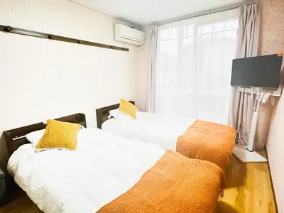 two beds sitting next to each other in a room at Liberty Corp 102 - Vacation STAY 18545 in Tokyo