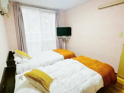 two beds in a room with a window at Liberty Corp 102 - Vacation STAY 18545 in Tokyo