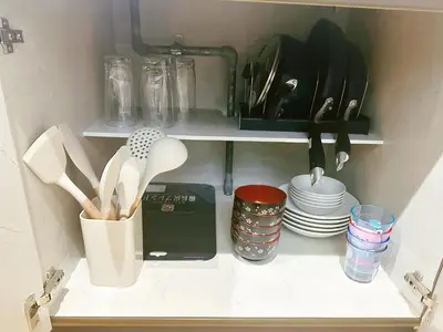 a kitchen cabinet with dishes and utensils in it at Liberty Corp 102 - Vacation STAY 18545 in Tokyo