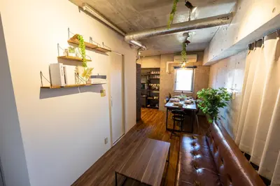 a hallway with a table in a room with white walls at Stayloop\u5e73\u4e95 in Tokyo
