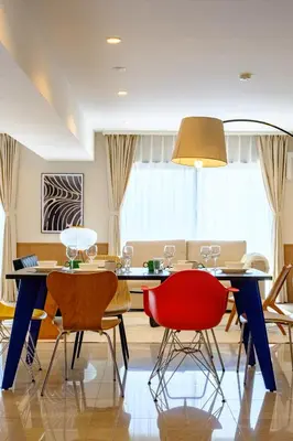 a dining room with a blue table and red chairs at Penthouse Apartment with Skytree View - 94sqm Luxury Suite - Miilo ASAKUSA EAST in Tokyo